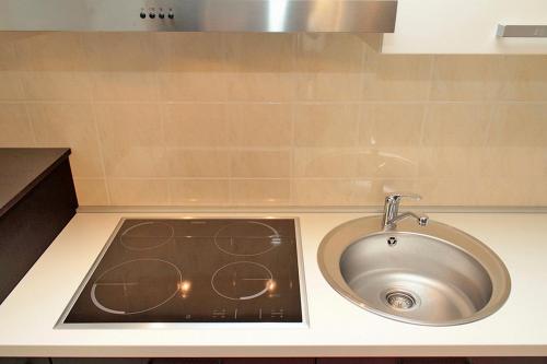 a sink in a kitchen with a counter top at Apartment Central City in Makarska
