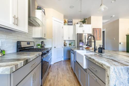a kitchen with white cabinets and blue counter tops at Flagstaff Route 66 Retreat in Flagstaff
