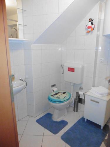 a bathroom with a toilet and a sink at Room Leon in Split