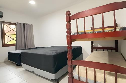 Ένα ή περισσότερα κρεβάτια σε δωμάτιο στο Casa de condomínio em Maresias - SP (5)