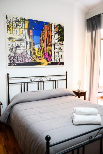 a bedroom with a bed with a painting on the wall at B&B Al Centro in Agrigento