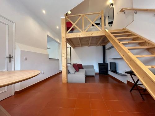 a loft apartment with a staircase and a living room at Estoril Haven in Cascais