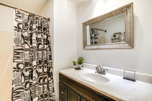 a bathroom with a sink and a mirror at 4 Mi to WKU Hilltoppers Hideaway with Grills! in Bowling Green