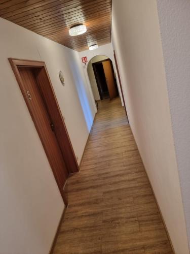 a hallway in an office building with wood floors at Gasthaus & Pension Bracki gusti in Baden-Baden