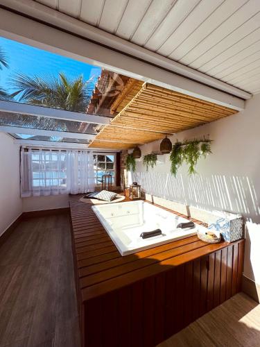 a kitchen with a sink and a large window at Hotel Boutique Recanto da Passagem in Cabo Frio
