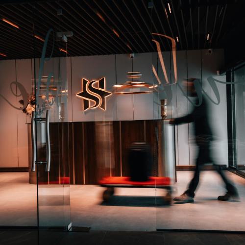 a person walking in front of a store window at Star Hill Hotel in Prishtinë