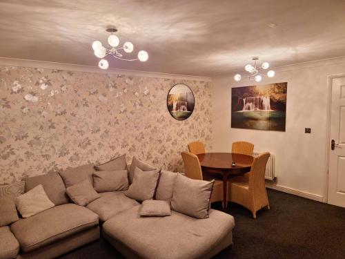 a living room with a couch and a table at Exotic Maidstone Home in Maidstone