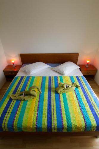 a bed with two slippers on top of it at Apartment Volme in Pula