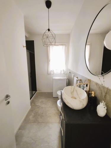 a bathroom with a sink and a mirror at L'incanto sui colli con giardino privato in Pianoro