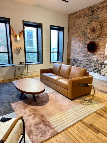 a living room with a couch and a table at Luxe 220, Unit 2 - Front Street Suite in Wilmington