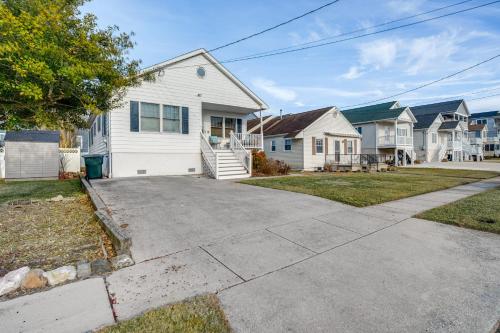a house with a driveway in a residential neighborhood at Walk to Brigantine Beach Home with BBQ and Yard in Brigantine