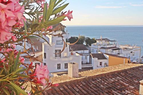 a view of a town with pink flowers at Burgau Charming House Villa in Burgau