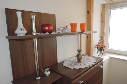 a shelf with vases and other items on it at CityCorner Appartment in Szczecin