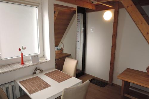 a dining room with a white table and a window at CityCorner Appartment in Szczecin