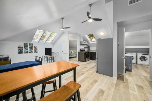 a kitchen and living room with a table and chairs at Cozy & Spacious Montrose Retreat with 3BR Near Houston Attractions in Houston