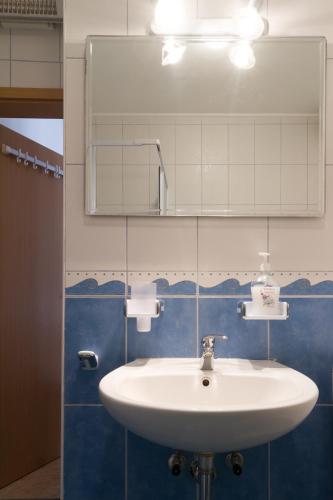 a bathroom with a white sink and a mirror at Apartment Volme in Pula