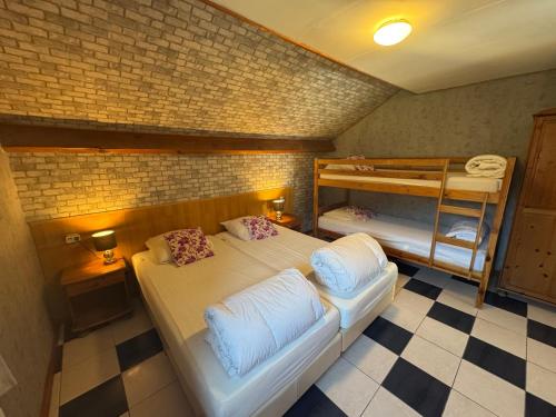 a room with two beds and a bunk bed at Villa Agni in Barvaux