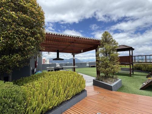 a garden with a wooden deck and a pavilion at Itsahome Selection - Torre Foresta - 3C in Quito