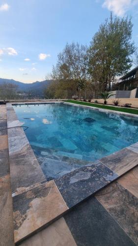 a large swimming pool with blue water at Casa Picone - Gerês in Ventosa