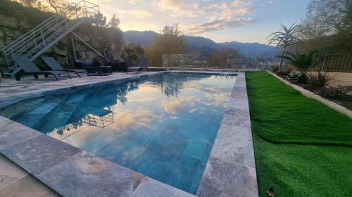 a swimming pool with blue water in a yard at Casa Picone - Gerês in Ventosa