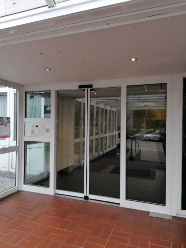a building with sliding glass doors with a view of a street at Penthousewohnung mit traumhaften Ausbilck auf den Segeberger See in Bad Segeberg