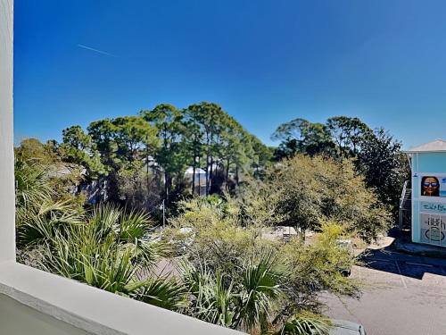 a view of a garden with trees and bushes at Cassine Station 305 - Sea Ya in Santa Rosa Beach