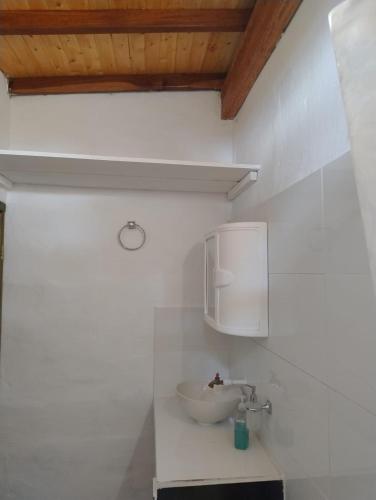 a bathroom with a sink on a white wall at Hospedaje tipo chalet Mesa de los Santos in Los Santos