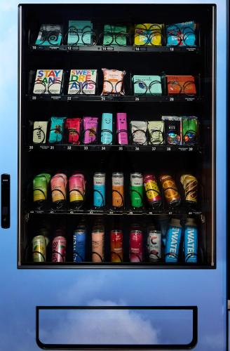 a vending machine filled with lots of different coloredools at Now Now NoHo in New York