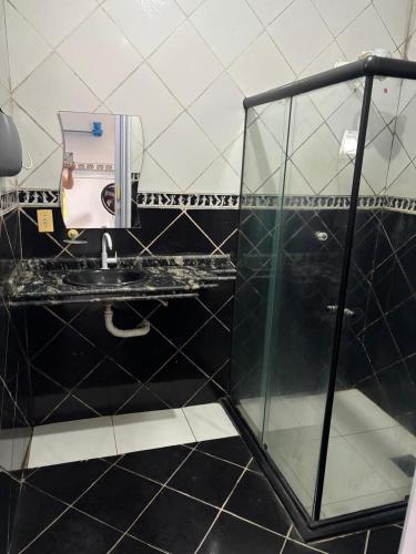 a bathroom with a glass shower and a sink at excelente casa para COP 30 in Belém