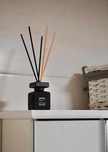 a black container with sticks in it sitting on a counter at Wilena Apartments in Villach