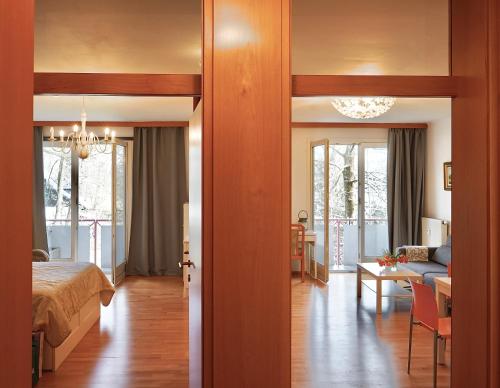 a bedroom with a bed and a living room at Wilena Apartments in Villach