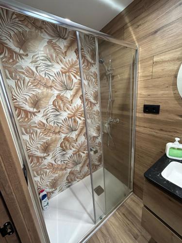a shower with a glass enclosure in a bathroom at Habitació amb encant a Blanes in Blanes