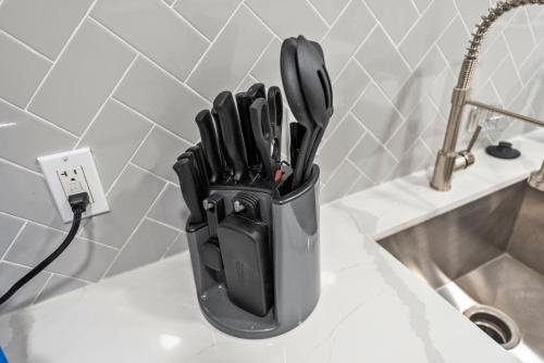 a knife block sitting on top of a sink at Montrose 1BR Apartment with Modern Vibes and Fast WiFi in Houston