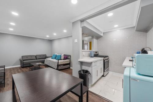 a kitchen and living room with a table and a couch at Montrose 1BR Apartment with Modern Vibes and Fast WiFi in Houston