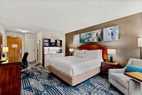 a hotel room with a bed and a desk and a couch at Delta Hotels by Marriott Mount Pleasant in Racine