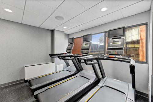 a gym with two treadmills in a room at Delta Hotels by Marriott Mount Pleasant in Racine