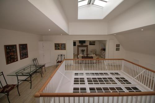 a large room with a skylight and a table and chairs at Prince Hill House in Devizes