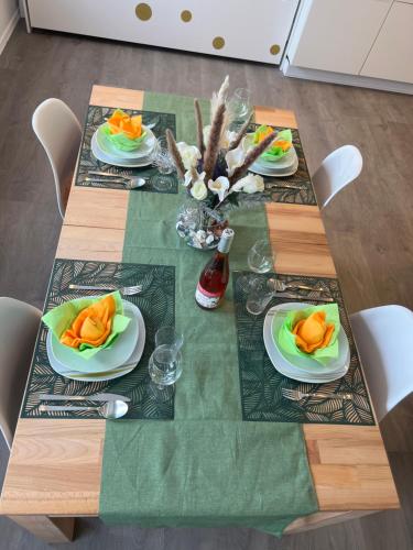 a table with plates of food on top of it at VipStay - Stilvoll und geräumige Apartments mit Terasse oder Balkon, Küche, kostenloses Parken, WLAN, Smart Tv in Wiesloch