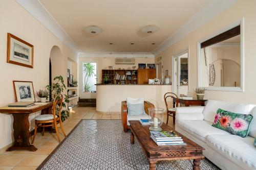 a living room with a white couch and a table at Hotel Senaria in Anacapri