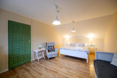 a bedroom with a bed and a green door at Turciansky dvor in Martin