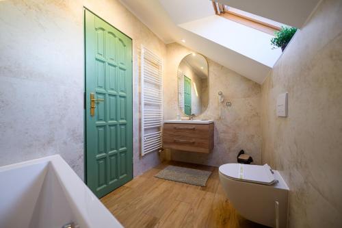 a bathroom with a green door and a sink at Turciansky dvor in Martin