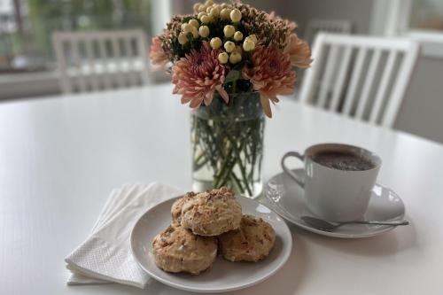 a table with a plate of cookies and a cup of coffee at Heron's Landing in Lummi Island