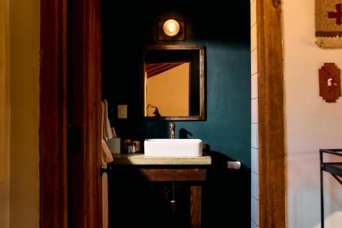a bathroom with a sink and a mirror at Pioneertown Motel in Pioneertown