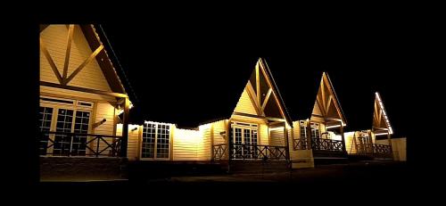 a lit up building at night with lights at CEDARS Resorts - Doodhpathri Kashmir in Rengazabal