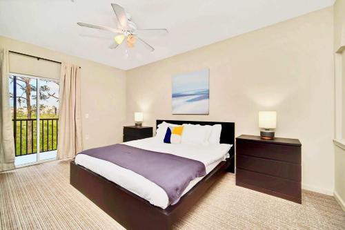 a bedroom with a bed and a ceiling fan at Near Disney - Spacious 3BR Condo with Pool in Orlando