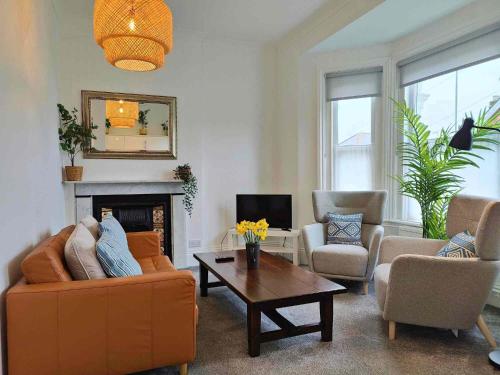 a living room with a couch and a coffee table at Fernhurst holiday apartments in Shanklin