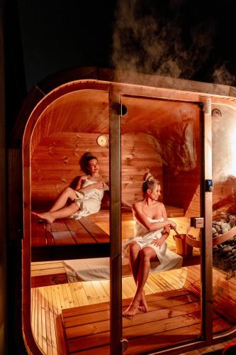 a group of people sitting in a sauna at Aparthotel Na Klenici in Mladá Boleslav