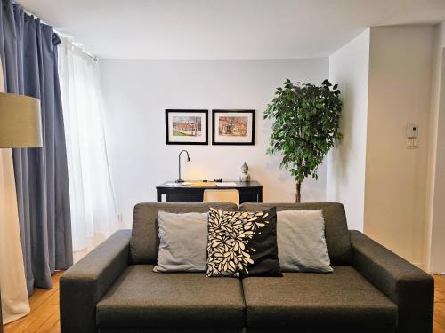 a living room with a couch and a table at Chez Edouard by Hébergements DCL in Quebec City
