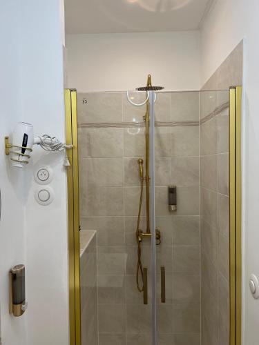 a shower with a glass door in a bathroom at TherezAss Holiday in Calais