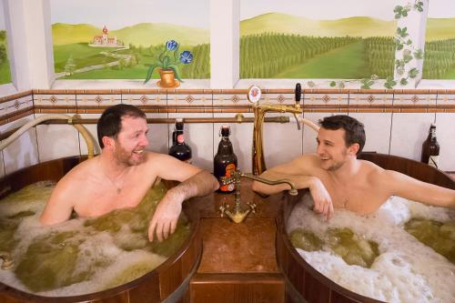 two men in jacuzzis in a hot tub at Landhotel Moorhof in Franking